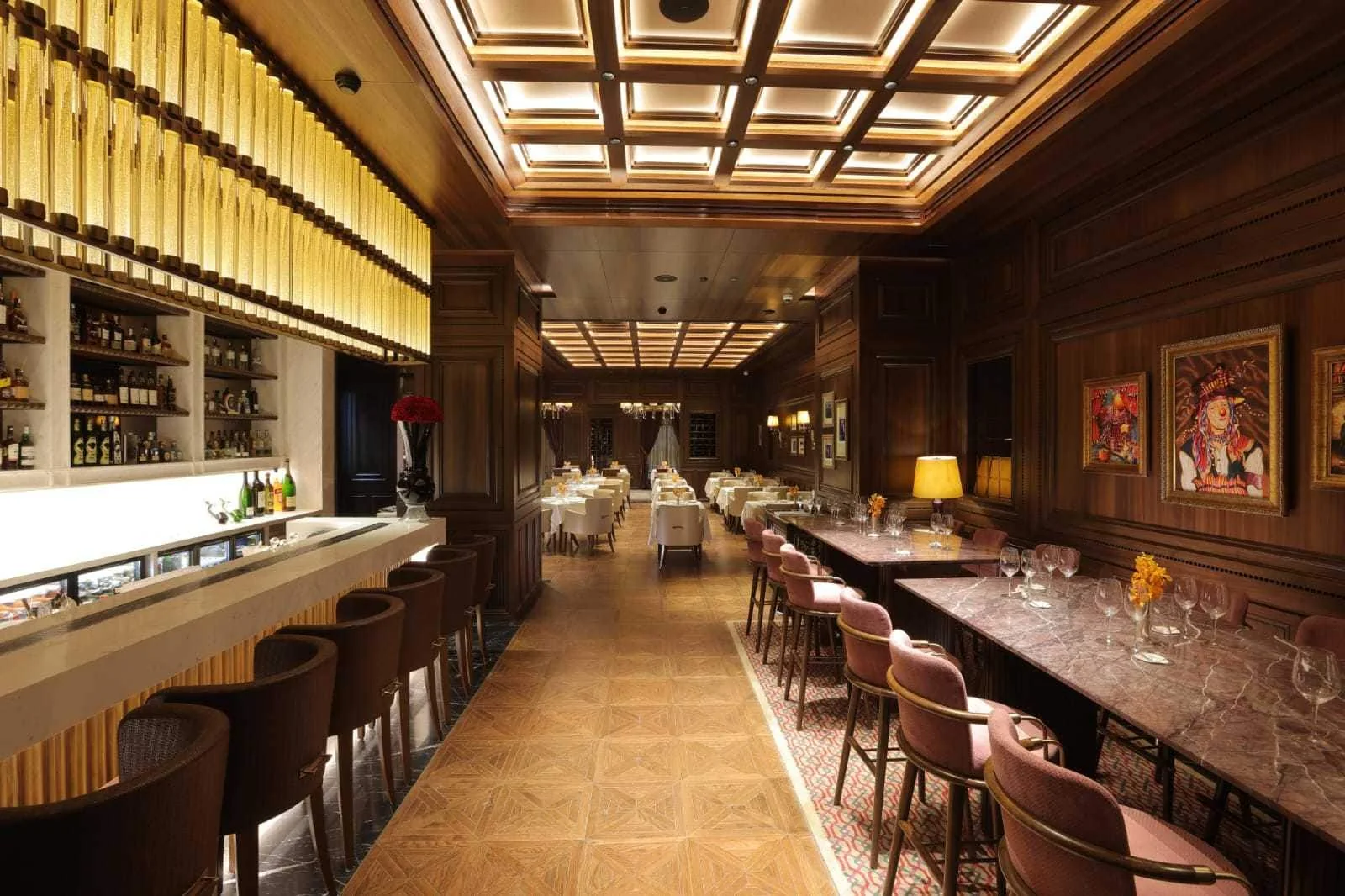 Warm timber, amber light and intimate tables inside a fine-dining room