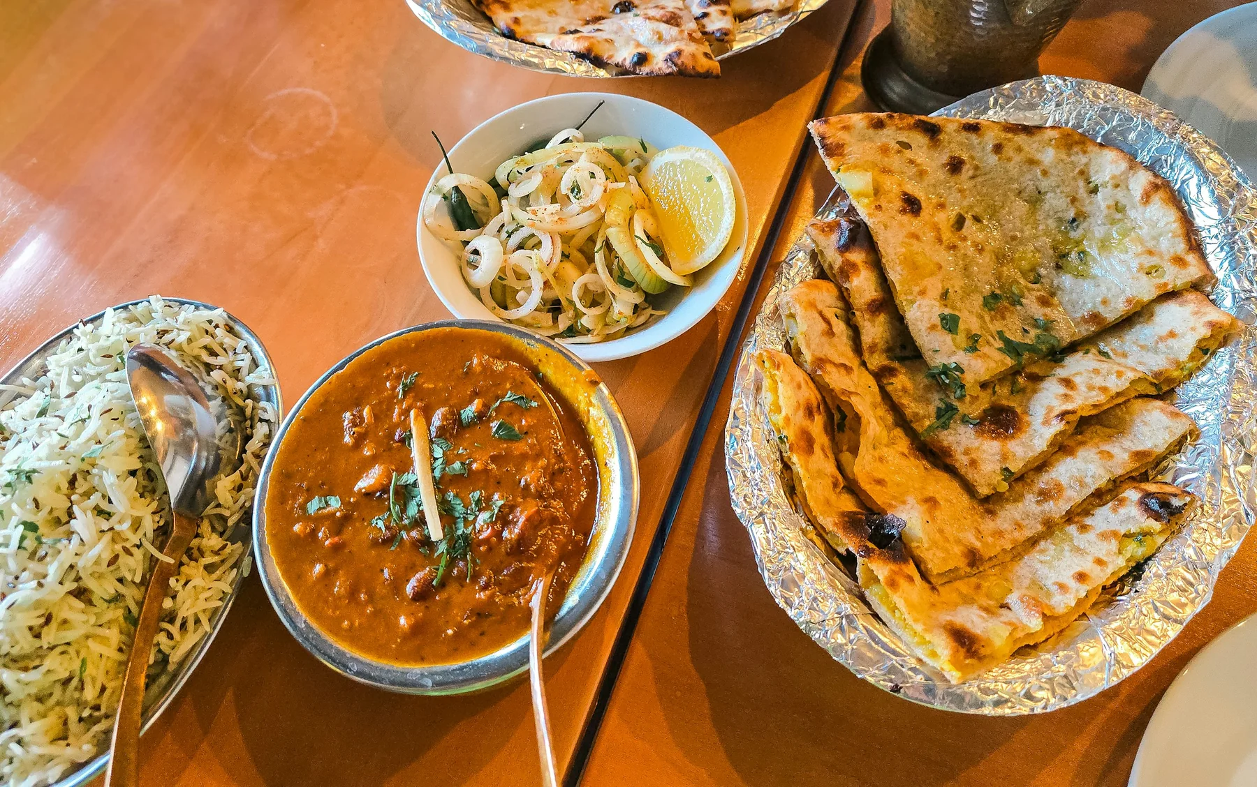 A richly spiced Indian curry and naan presented at an intimate restaurant table